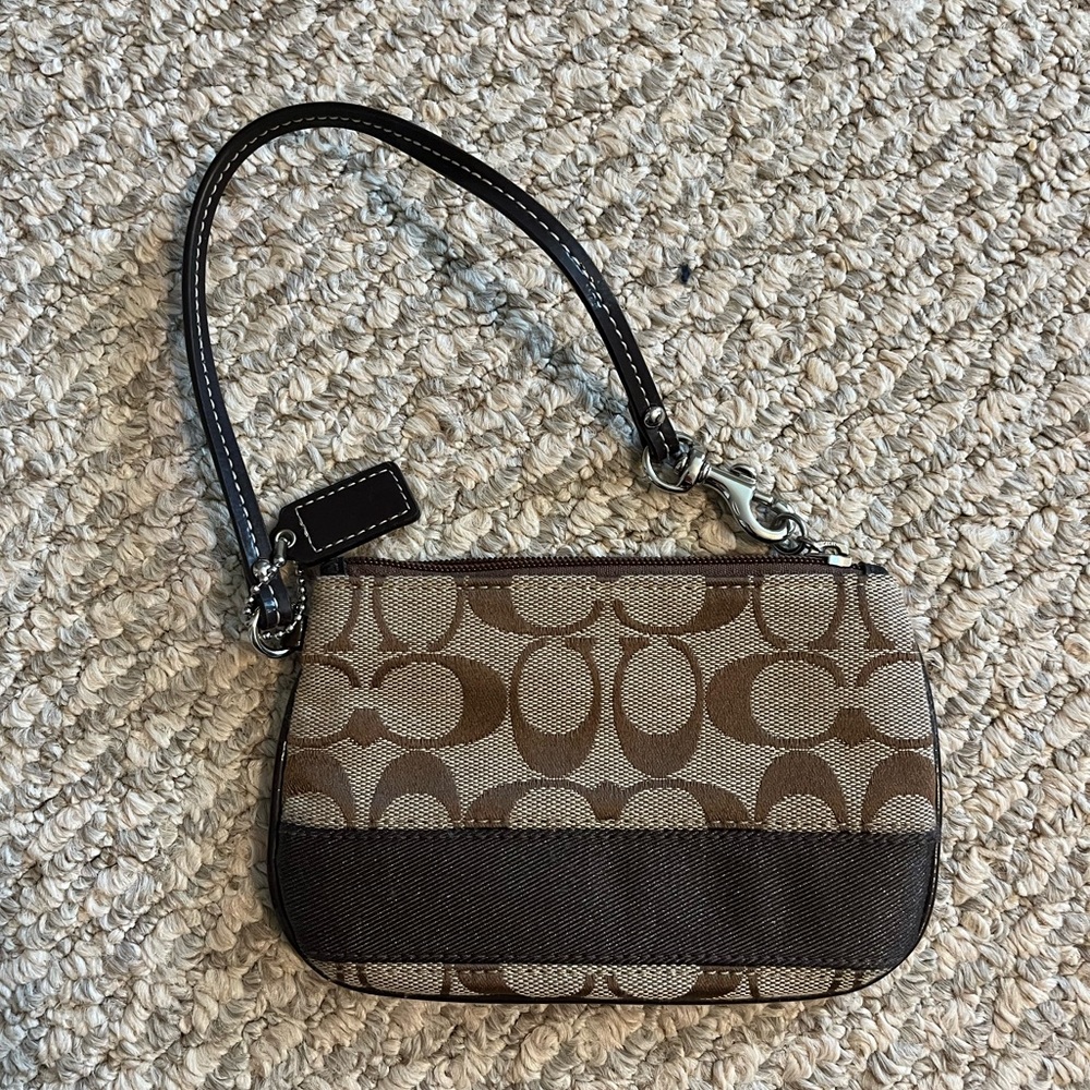 COACH wristlet with signature logo. NWOT, never used.